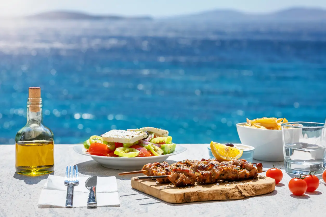 Seaside meal with salad and skewers.